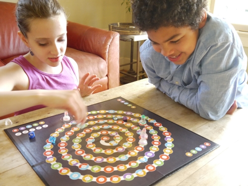 Children play Dan Finkle ’02's math-based board game, Prime Climb.